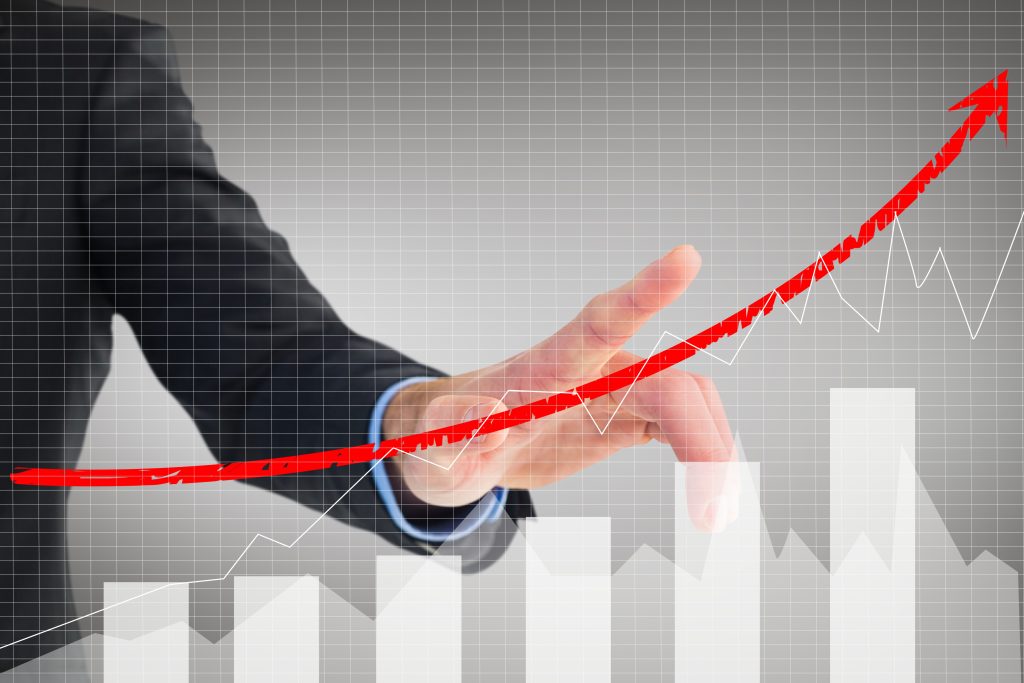composite of businessman pointing at rising graph because of Google ads